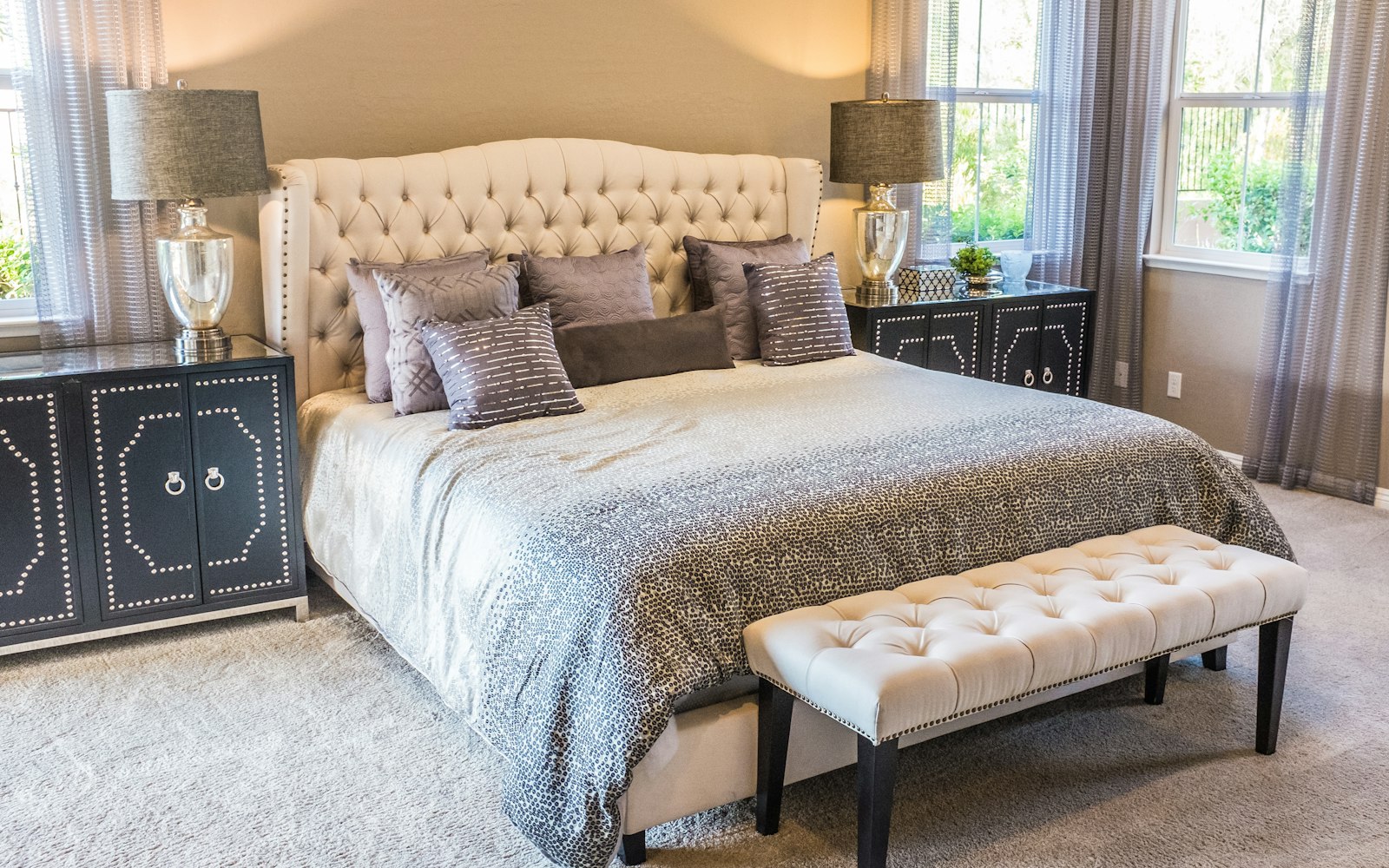 Dormitorio con la cama hecha y lámparas en las mesillas
